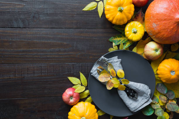 istock Frame of pumpkin and maple leaves on wooden board. Fall. Top view. Copy space. 1267580506