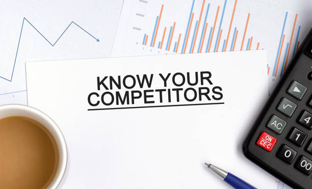 istock KNOW YOUR COMPETITORS document with graphs, diagrams and calculator and a cup of fragrant coffee 1267581406