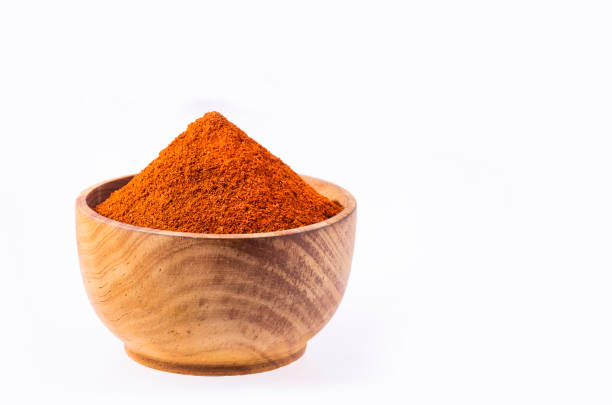 Paprika powder in a wooden bowl - Capsicum annuum
