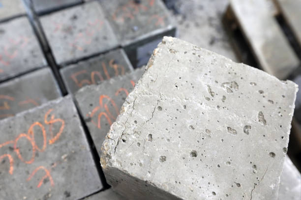 istock Cracks of the cubic concrete sample after the tensile or flexural testing (compressive strength test). 1267591857