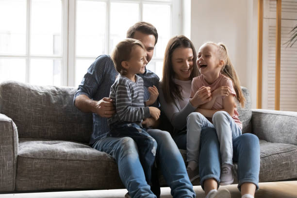istock Joyful young parents having fun with little laughing children. 1267591940