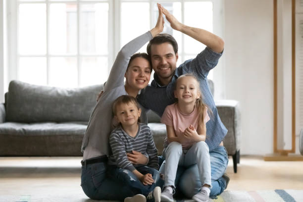 istock Happy spouses having fun with small kids, making love sign. 1267591962