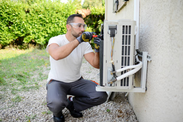 istock handsome young man electrician installing an air conditioning in a client house 1267592323