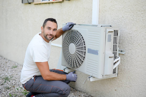 istock handsome young man electrician installing an air conditioning in a client house 1267592325
