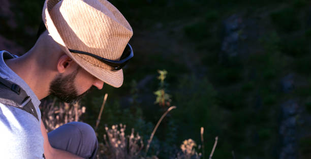 istock Handsome hispanic male trekker looking down with copy space 1267593830