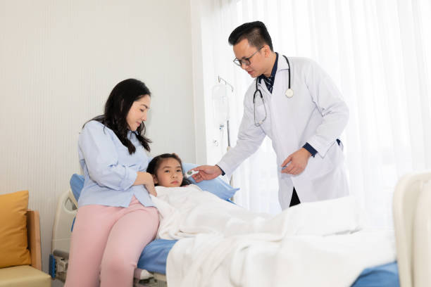 istock asian doctor checking temperature to child's ear 1267608271