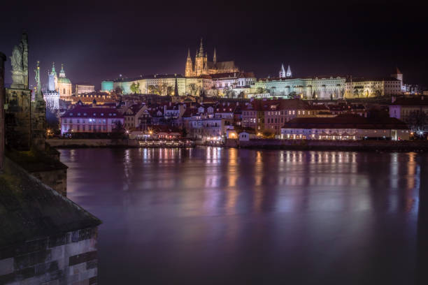 prague panorama with charles bridge and vltava river at night – czech republic - prague mirrored pattern bridge architecture imagens e fotografias de stock