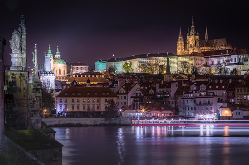 Prague panorama with Bridges, boat motion and Vltava river at night – Czech Republic