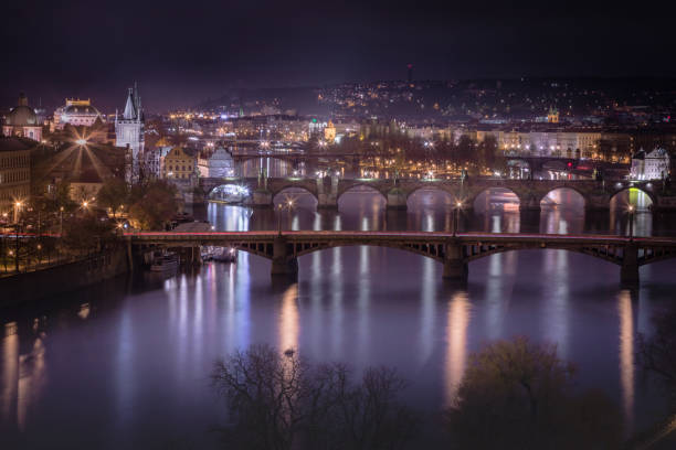 prague panorama with bridges reflection in vltava river at night – czech republic - prague mirrored pattern bridge architecture imagens e fotografias de stock