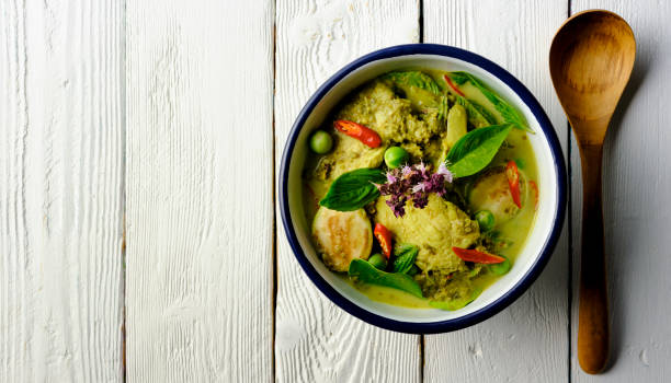 istock Famous internationally renowned Thai green coconut curry 'Gaeng Keow Wan Gai', with chicken.with chicken, in a bowl with serving spoon. 1267610844