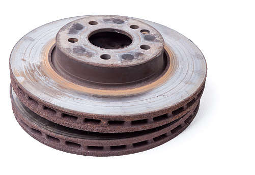 Metal brake discs on a white isolated background in a photo studio of auto parts for replacement in the repair of the chassis or for a catalog of spare parts for sale on auto disassembly.