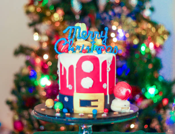Merry Christmas topper on a santa themed christmas cake stock photo
