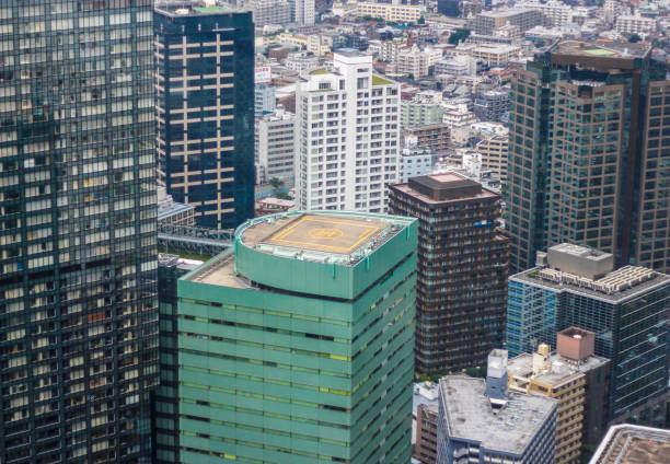 Views of Tokyo city buildings, and a helipad ontop of a building stock photo
