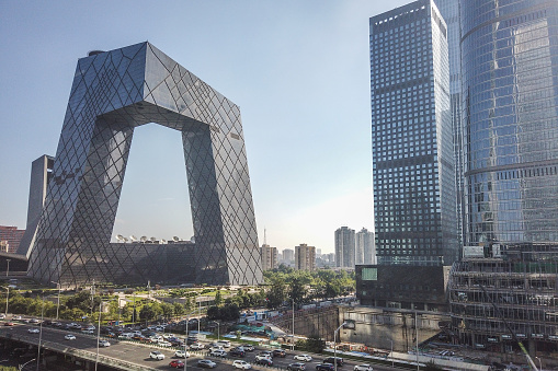 Beijing, China –  August 10, 2020: cars driving in rush hour on the Guagnhua road in the East 3rd Ring of the city in the morning with the backgroud China Central Television Tower.