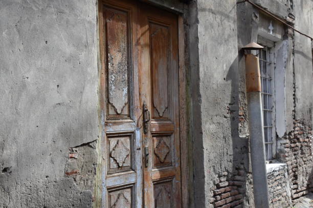 istock Weathered Townhouse Facade with Wainscoted Double Doors 1267625558