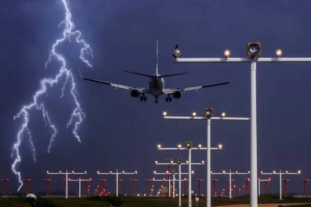 Photo of commercial airplane landing in extreme weather with thunderstorm