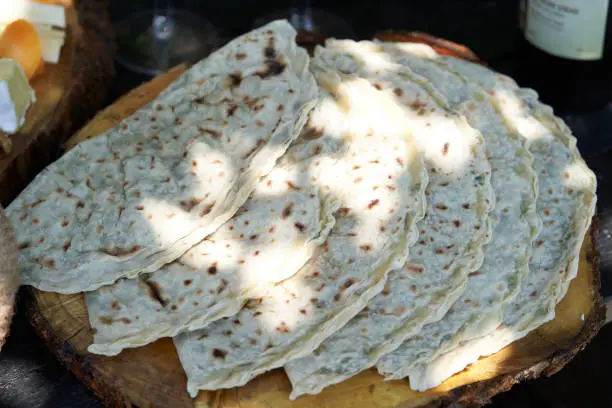 Photo of Azerbaijani traditional cuisine - Kutabs or Gozleme with herbs or meat