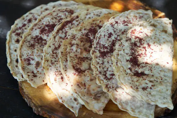 Photo of Azerbaijani traditional cuisine - Kutabs or Gozleme with herbs or meat