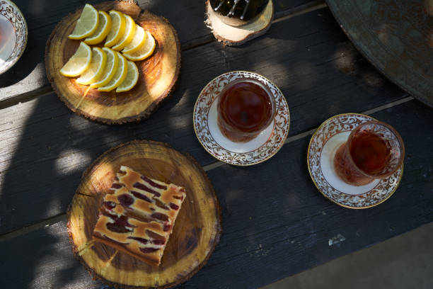 istock Breakfast table with apple pie, tea glass, outdoors. Homemade Apple Pie 1267629320