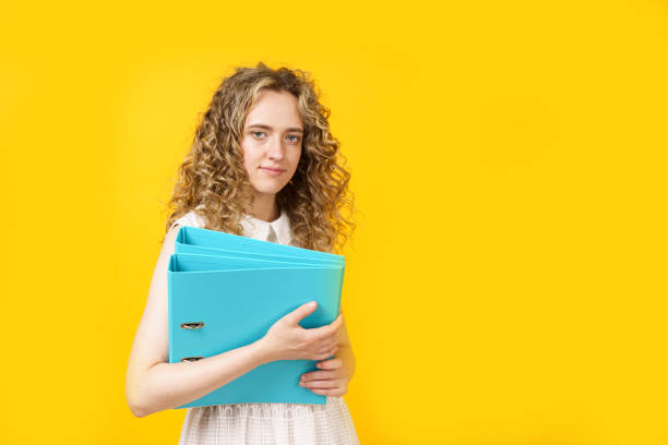 istock A young woman holds folders with documents in her hands. 1267631335