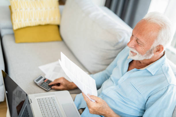 istock Happy mature man going through his financials. 1267633305