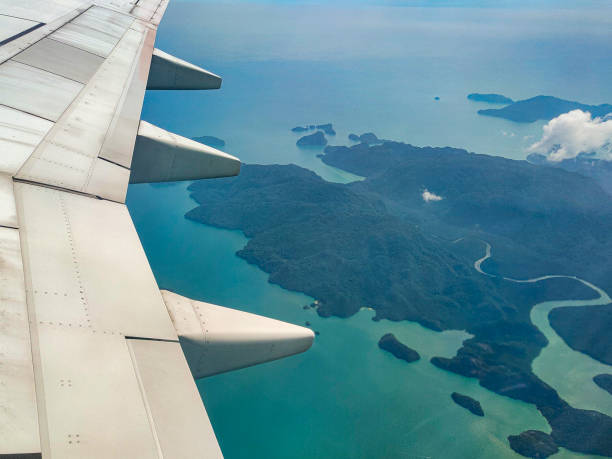 istock A view from passenger window from commercial airplane looking at the airplane wing and cloud at langkawi 1267634247