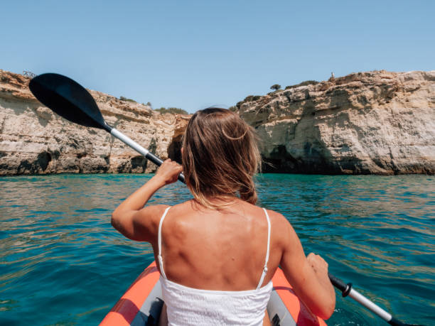 istock Rear view of woman on canoe 1267635116