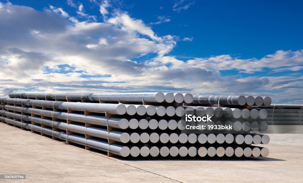 industrial raw materials, heap of aluminium bar in aluminium profiles factory. Aluminum Stock Photo