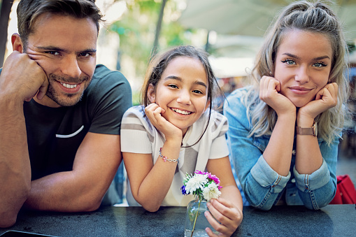 Portrait of happy family in a cafe