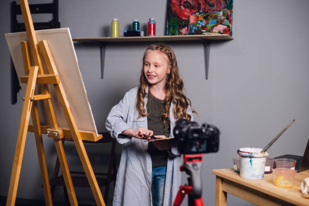 istock a young blogger girl at home leads a remote masterclass on drawing pictures during quarantine 1267644360