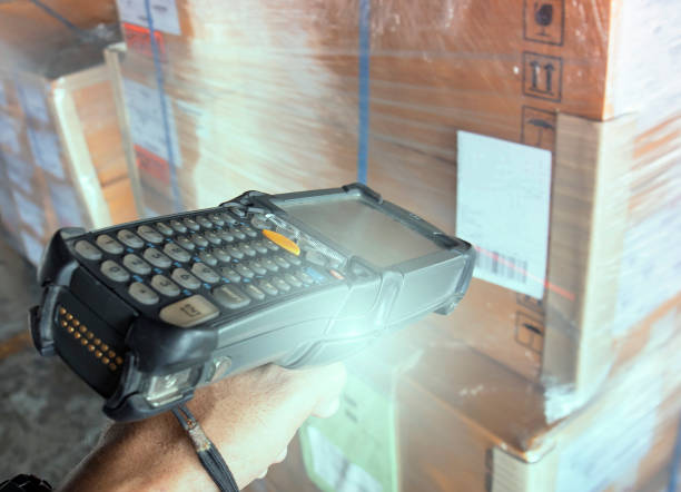 istock Worker scanning bar code scanner with label of goods. Computer equipment for warehouse inventory management. 1267648269