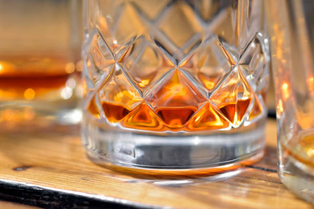 istock Three glasses of whiskey erected toast 1267649794