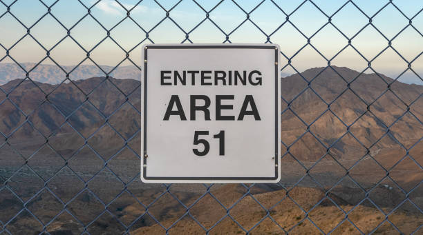Entering Area 51 Sign Entering Area 51 Sign On A Fence At The Military Base In The Nevada Desert At Sunset military invasion photos stock pictures, royalty-free photos & images