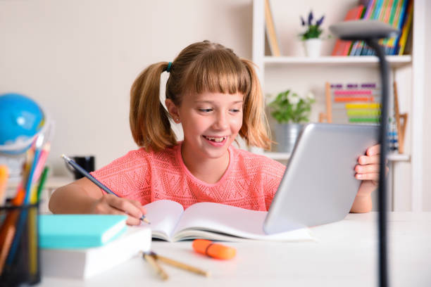 istock Girl studying at home taking distance lessons with digital tablet 1267651971