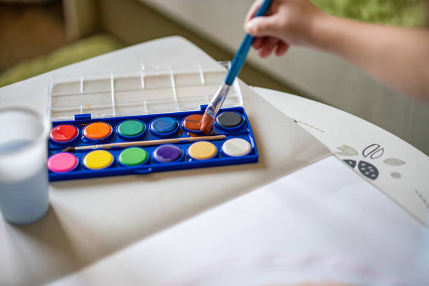 istock Close-up boy is start to paint with watercolor 1267652555