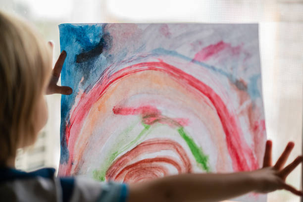 istock Little boy put his rainbow on window during epidemic coronavirus 1267652597