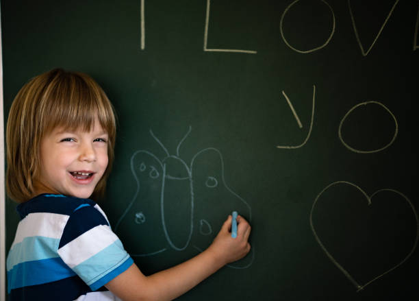 istock Little boy is drawing a butterfly 1267652667