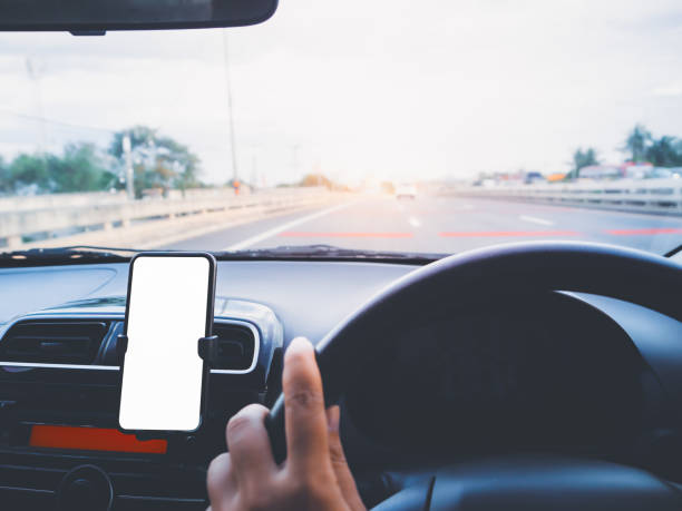 istock Blank empty screen smartphone on holder in car use for Navigation or GPS. Car interior view. 1267652751