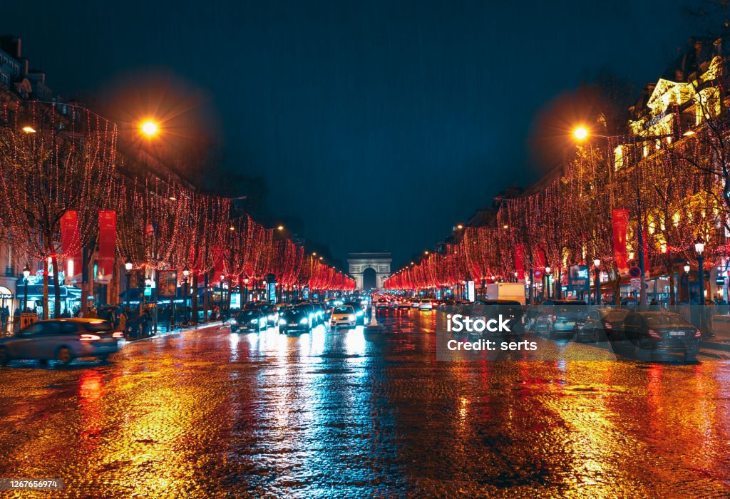 Avenue des Champs-Elysees and Arc de Triomphe Motion blurred cars on Champs Élysées and Arc de Triomphe with Christmas city lights Night Stock Photo