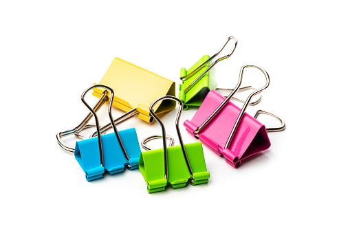Office or school supplies: multicolored binder clips heal isolated on white background. High resolution 42Mp studio digital capture taken with Sony A7rII and Sony FE 90mm f2.8 macro G OSS lens