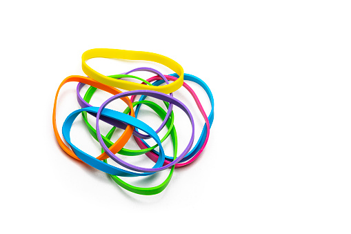 Office or school supplies: Multicolored rubber bands heap isolated on white background. High resolution 42Mp studio digital capture taken with Sony A7rII and Sony FE 90mm f2.8 macro G OSS lens