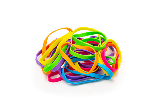 Office or school supplies: Multicolored rubber bands heap isolated on white background. High resolution 42Mp studio digital capture taken with Sony A7rII and Sony FE 90mm f2.8 macro G OSS lens