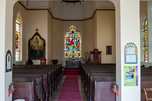 Luderitz, Namibia - June 14, 2011: Inside of  the Lutheran Church in Luderitz. Stained glass window are visible