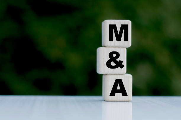 The concept of the word M&A on cubes on a beautiful green background The concept of the word M&A on cubes on a beautiful green background. Business concept mergers and acquisitions photos stock pictures, royalty-free photos & images