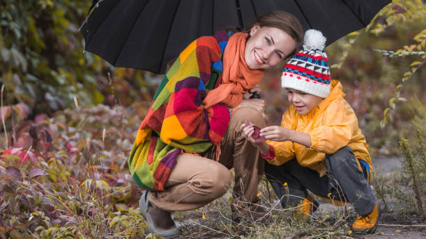 istock Happy family having fun in autumn park 1267665106