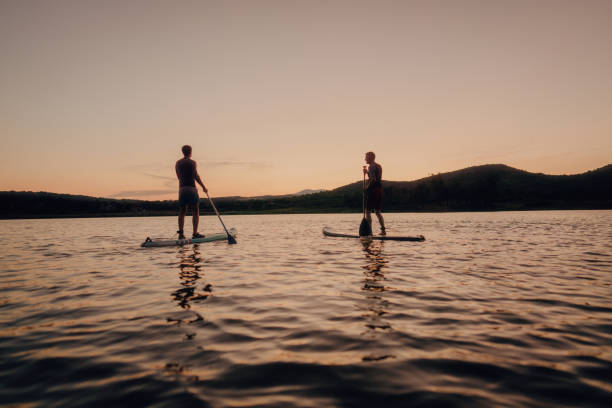istock Father and son stand-up paddling on a lake 1267666175