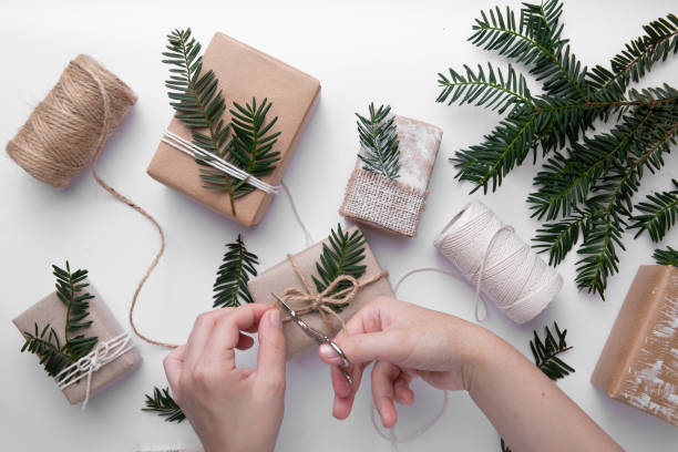 istock Hands is making gifts for Christmas on white background 1267667120