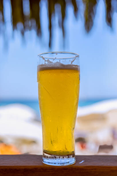 istock Glass of cold beer at a beach bar (Vertical Photo) 1267670362