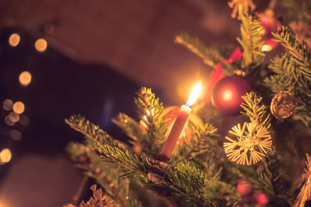 istock Candle on traditional decorated Christmas tree, evening 1267671348