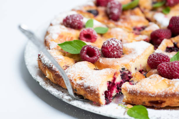 Homemade sweet raspberry fruit pie sliced and served on a plate flat lay tabletop view